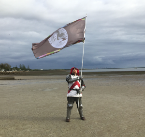 Sir Ashley Dean holds the flag aloft